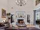 Elegant living room with fireplace, hardwood floors, and view to the kitchen at 124 Belford Way, Locust Grove, GA 30248