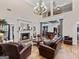 Comfortable living room with a stone fireplace, hardwood floors, and plenty of seating at 124 Belford Way, Locust Grove, GA 30248