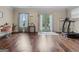 Bright living room featuring gleaming hardwood floors, natural light, and access to the backyard at 124 Belford Way, Locust Grove, GA 30248