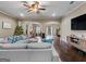 Large open concept living room with hardwood floors, ceiling fan and comfortable couch at 124 Belford Way, Locust Grove, GA 30248