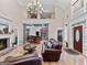 Spacious living room featuring hardwood floors, fireplace, and an open layout at 124 Belford Way, Locust Grove, GA 30248