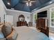Cozy main bedroom featuring dark ceilings, wood furniture, and natural lighting at 124 Belford Way, Locust Grove, GA 30248