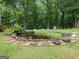 Charming backyard pond surrounded by lush greenery, creating a tranquil oasis at 124 Belford Way, Locust Grove, GA 30248