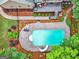 Aerial view of a backyard featuring a pool, patio, landscaping, and outdoor seating at 124 Belford Way, Locust Grove, GA 30248