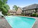 Sparkling pool with a slide, complemented by a spacious patio and lush landscaping at 124 Belford Way, Locust Grove, GA 30248