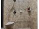 Updated shower with neutral tiling, showerhead, and built in soap rack at 124 Belford Way, Locust Grove, GA 30248