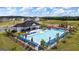 Aerial shot of community pool and clubhouse with lounge chairs, umbrellas, playground, and manicured landscaping at 178 Aster, Locust Grove, GA 30248