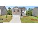 Charming two-story home with a brick and siding exterior, two-car garage, and well-manicured front yard at 178 Aster, Locust Grove, GA 30248