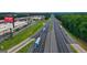 Aerial view showcasing the proximity to Tanger Outlets and a major highway for convenient access at 178 Aster, Locust Grove, GA 30248