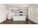 Modern kitchen featuring granite countertops, stainless steel appliances, an island, and ample cabinet space at 178 Aster, Locust Grove, GA 30248