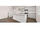 Well-lit kitchen featuring an island with granite countertops, pantry, stainless steel appliances, and wood flooring at 178 Aster, Locust Grove, GA 30248