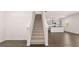 Staircase leading to the upper level with white railing and carpeted steps at 178 Aster, Locust Grove, GA 30248