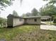Backyard with grass, partial view of a carport, and the exterior of the house at 438 Fedora Nw Way, Atlanta, GA 30331