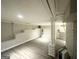 Spacious basement with painted brick accents and wood-look flooring, perfect for customization at 438 Fedora Nw Way, Atlanta, GA 30331