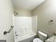 Bathroom featuring a shower-tub combo, neutral walls, and updated fixtures for modern comfort at 438 Fedora Nw Way, Atlanta, GA 30331