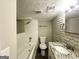 Updated bathroom features a tub-shower combo, granite vanity, and painted brick accents at 438 Fedora Nw Way, Atlanta, GA 30331