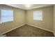 Cozy bedroom featuring neutral carpeting, two bright windows, and ample space for furniture at 438 Fedora Nw Way, Atlanta, GA 30331