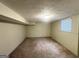 Cozy bedroom with neutral carpet and natural light from a window; ideal for relaxation at 438 Fedora Nw Way, Atlanta, GA 30331