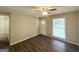 Cozy living room featuring hardwood floors, neutral paint, and plenty of natural light through the window at 438 Fedora Nw Way, Atlanta, GA 30331