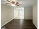 Comfortable living room with hardwood floors, ceiling fan, and a smooth transition to the dining area at 438 Fedora Nw Way, Atlanta, GA 30331