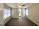 Spacious main bedroom with plush carpet, bright windows, and an en-suite bathroom for convenience at 438 Fedora Nw Way, Atlanta, GA 30331