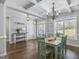 The dining area features a coffered ceiling, wood floors, and stylish table setting at 92 Gordon Oaks Way, Moreland, GA 30259