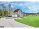 A three-car garage and a driveway lead to this home's welcoming facade at 92 Gordon Oaks Way, Moreland, GA 30259