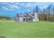Large, gray, two-story home surrounded by greenery and an extensive lawn at 92 Gordon Oaks Way, Moreland, GA 30259