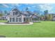 Beautiful two-story home with a green lawn, gray siding, and a welcoming front entrance at 92 Gordon Oaks Way, Moreland, GA 30259