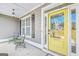 Charming front porch with yellow door, seating, and stylish accents at 92 Gordon Oaks Way, Moreland, GA 30259
