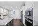Bright kitchen with stainless steel appliances, granite countertops, and hardwood floors at 92 Gordon Oaks Way, Moreland, GA 30259