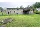 Backyard view of a two story home featuring a wood deck, gray painted brick, and a chain link fence at 1889 Silver Creek Dr, Austell, GA 30168