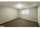 Bedroom featuring plush carpeting, neutral walls, and a bright window at 1889 Silver Creek Dr, Austell, GA 30168