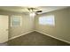 Bedroom featuring plush carpeting, neutral walls, and two bright windows with a ceiling fan at 1889 Silver Creek Dr, Austell, GA 30168