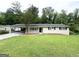 Charming single-story home featuring a spacious front lawn and a convenient covered carport at 1889 Silver Creek Dr, Austell, GA 30168