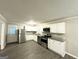 Modern kitchen with stainless steel appliances, white cabinets, and granite countertops at 1889 Silver Creek Dr, Austell, GA 30168