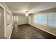 Bright living room with wood floors, ceiling fan, and large windows offering ample natural light at 1889 Silver Creek Dr, Austell, GA 30168