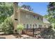 Exterior of home showing wooden deck with chairs, grill and access to mature backyard at 121 Tamerlane, Peachtree City, GA 30269