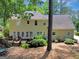 Exterior view of a home featuring a deck, mature trees and landscaping at 121 Tamerlane, Peachtree City, GA 30269