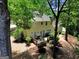 View of the backyard featuring a wood deck, patio furniture, a grill, and mature trees at 121 Tamerlane, Peachtree City, GA 30269