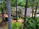 Overhead view of the backyard featuring a wood deck, patio furniture, a grill, and mature trees at 121 Tamerlane, Peachtree City, GA 30269