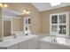 Bright bathroom with dual sinks, soaking tub, and natural light at 121 Tamerlane, Peachtree City, GA 30269