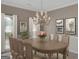 Dining room with large table, chairs, artwork, and chandelier at 121 Tamerlane, Peachtree City, GA 30269