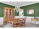 Traditional dining room featuring a wood table, chairs, hutch, and elegant chandelier, perfect for Gathering gatherings at 121 Tamerlane, Peachtree City, GA 30269
