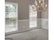 Traditional dining room with two large windows and chandelier at 121 Tamerlane, Peachtree City, GA 30269