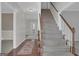 Inviting entryway with a staircase, hardwood floors, and an open view to the formal living area at 121 Tamerlane, Peachtree City, GA 30269