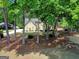 View of a two-story home through the trees featuring a well-maintained front yard at 121 Tamerlane, Peachtree City, GA 30269