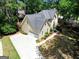 Aerial view of a two-story home featuring an attached two-car garage and mature landscaping at 121 Tamerlane, Peachtree City, GA 30269