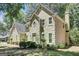 Well-manicured lawn surrounding the home's exterior is visible, complemented by mature trees for added privacy at 121 Tamerlane, Peachtree City, GA 30269
