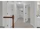 Upstairs hallway with neutral color palette and multiple doors at 121 Tamerlane, Peachtree City, GA 30269